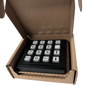 Keypad device inside an open cardboard box on a white background